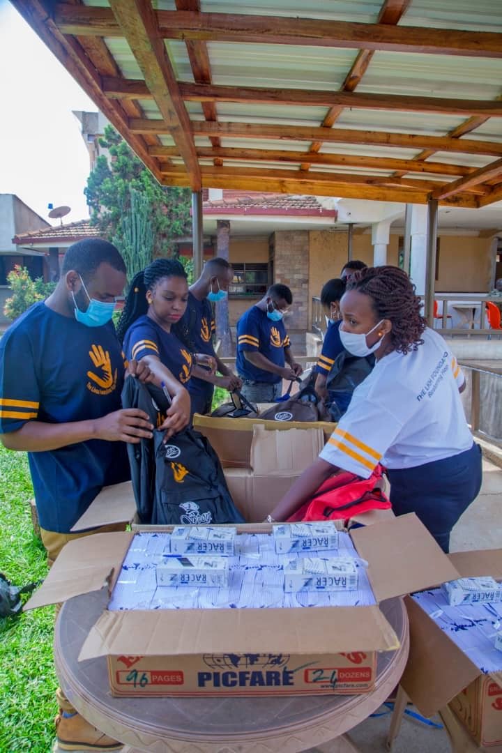 LKH members assemble bags and pack books and pens into them in preparation for donation at Namugoona Kigobe Primary School