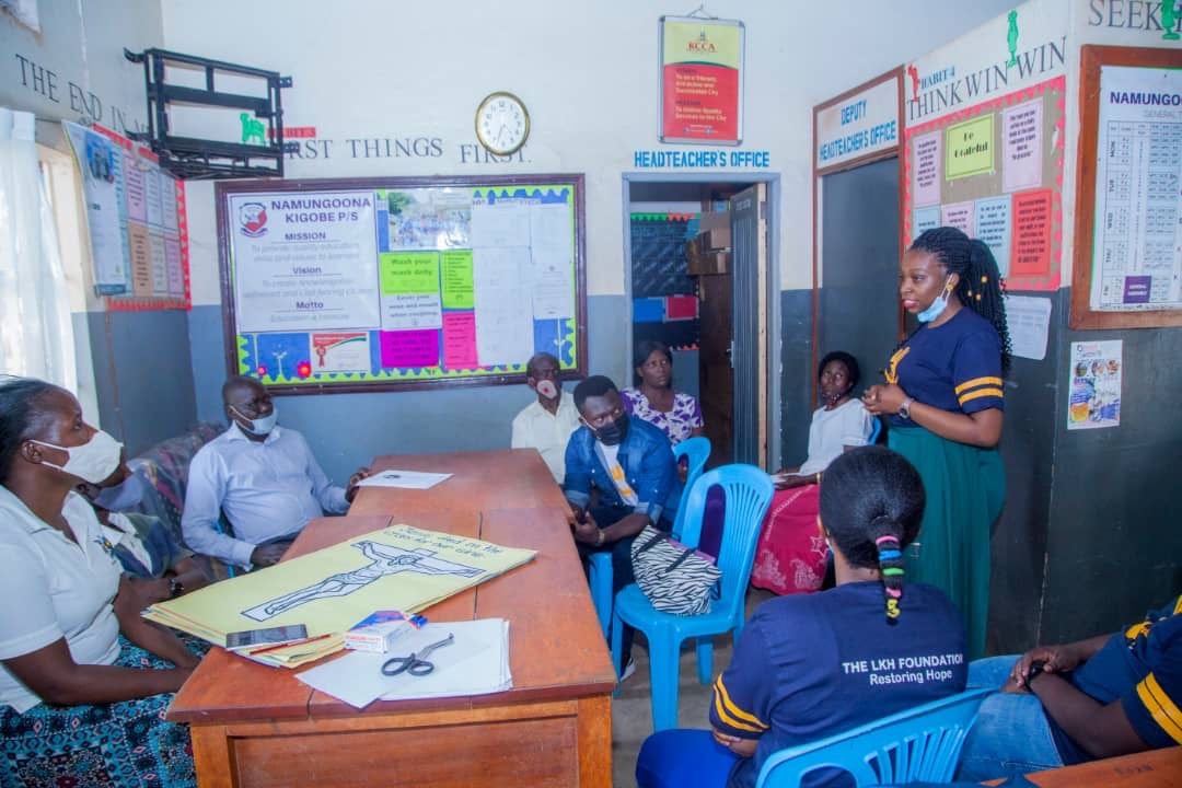 Livas, the founder of LKH,  engages in a discussion with the headteacher and staff of Namugoona Kigobe Primary School ( a UPE school ) concerning the welfare of  the students.